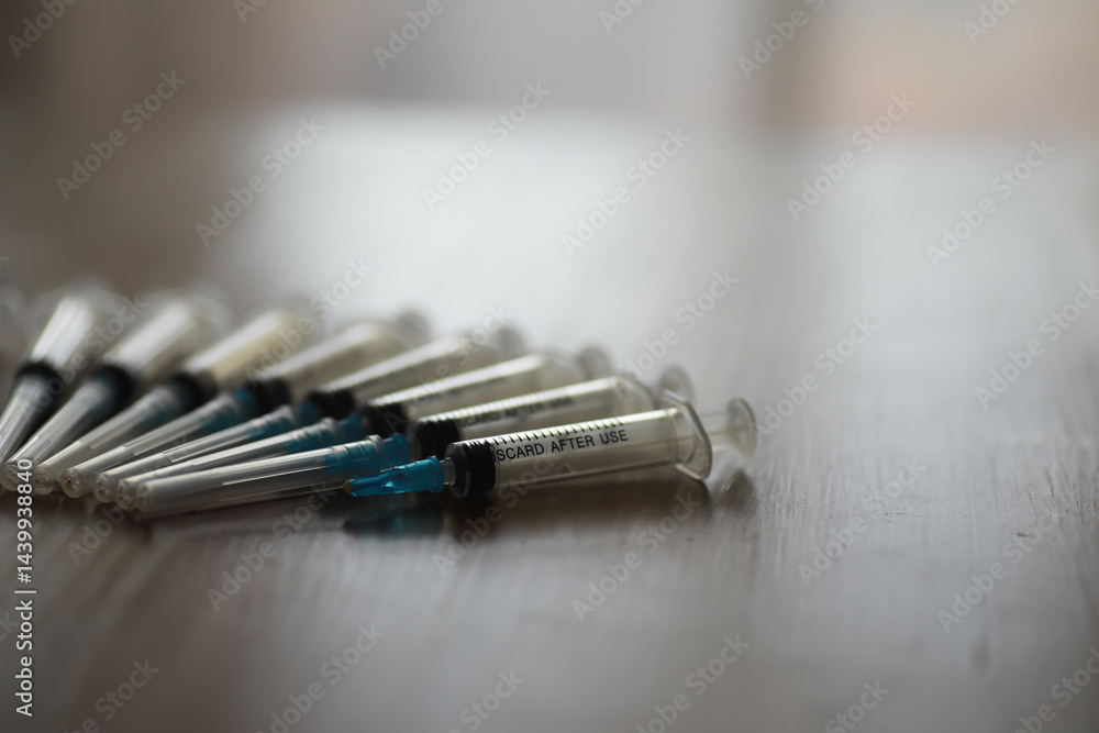 Close-up of Syringes on Wooden Surface Highlighting Medical Supplies and Vaccination