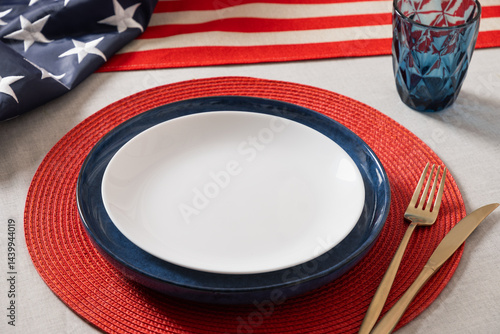 American table setting for USA Independence Day. Festive dinner decorated in USA national flag colors white, red and blue. Close up. Copy space.