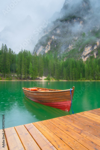 Obraz na płótnie Boat on Lake Braies, Dolomites, Italy. Lake and reflections on the water surface. Mountain landscapes in summer. Place for mountain hiking, travel and vacation. Wallpaper, postcard, photo. w salonie