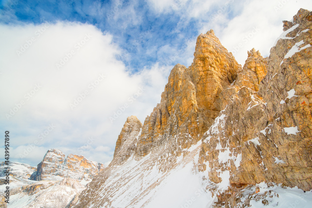 View of the Dolomites, Italy. Mountain landscapes with snow and ice. Sharp rocks as a background. Place for mountain hiking, traveling and vacation. Wallpaper, postcard, photo.