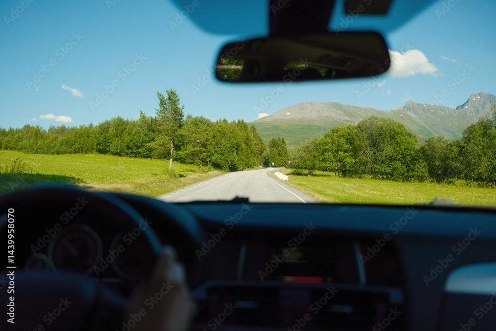 View of the road from inside the car. Traveling by car. View of the road and the panel of the car. Driving on an asphalt road. Man behind the wheel. Wallpaper, postcard, background.