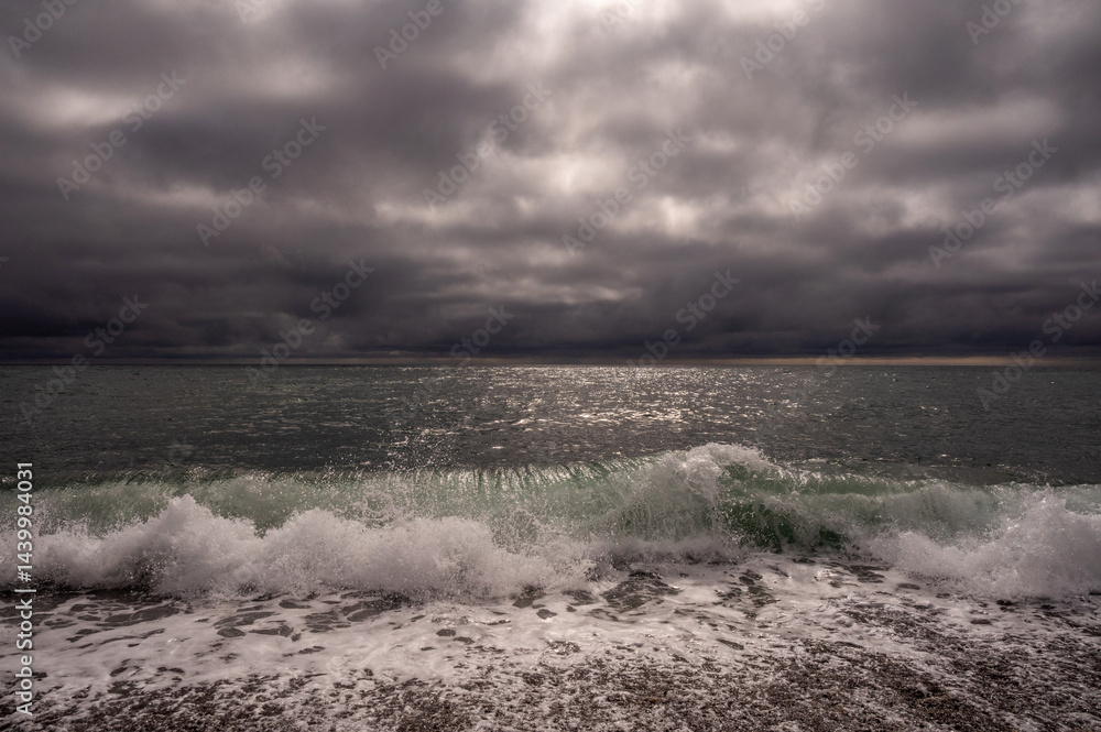 Dark storm clouds over ocean. Dramatic seascape. Clouds and rain flurry over sea.
