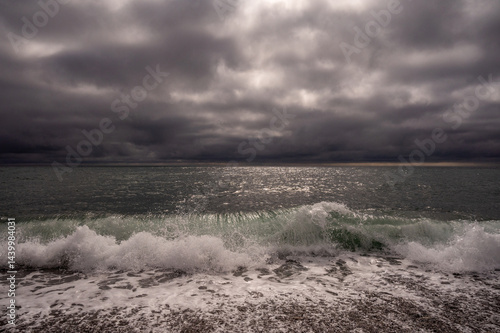 Obraz na płótnie Dark storm clouds over ocean. Dramatic seascape. Clouds and rain flurry over sea. w salonie