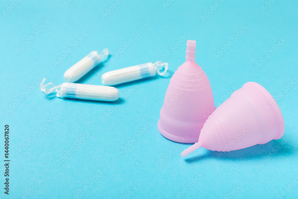 Menstrual cup on a bright background. Sanitary napkins, tampons and menstrual cup.Concept of critical days, menstruation.feminine hygiene product. Women health concept.Premenstrual syndrome.Copy space