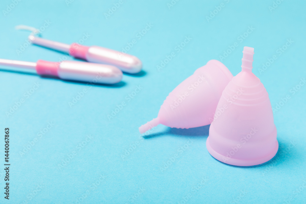 Menstrual cup on a bright background. Sanitary napkins, tampons and menstrual cup.Concept of critical days, menstruation.feminine hygiene product. Women health concept.Premenstrual syndrome.Copy space