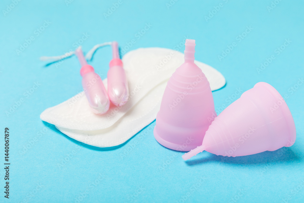 Menstrual cup on a bright background. Sanitary napkins, tampons and menstrual cup.Concept of critical days, menstruation.feminine hygiene product. Women health concept.Premenstrual syndrome.Copy space