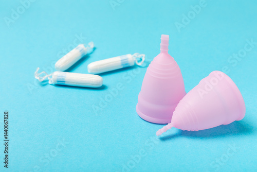 Obraz na płótnie Menstrual cup on a bright background. Sanitary napkins, tampons and menstrual cup.Concept of critical days, menstruation.feminine hygiene product. Women health concept.Premenstrual syndrome.Copy space w salonie