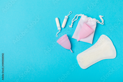 Obraz na płótnie Menstrual cup on a bright background. Sanitary napkins, tampons and menstrual cup.Concept of critical days, menstruation.feminine hygiene product. Women health concept.Premenstrual syndrome.Copy space w salonie