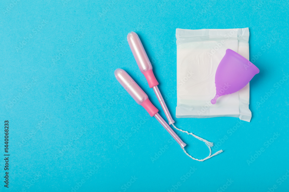 Menstrual cup on a bright background. Sanitary napkins, tampons and menstrual cup.Concept of critical days, menstruation.feminine hygiene product. Women health concept.Premenstrual syndrome.Copy space