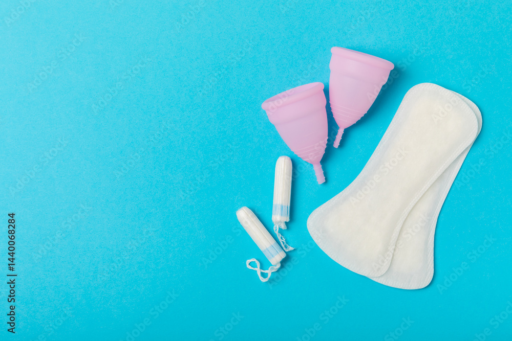 Menstrual cup on a bright background. Sanitary napkins, tampons and menstrual cup.Concept of critical days, menstruation.feminine hygiene product. Women health concept.Premenstrual syndrome.Copy space