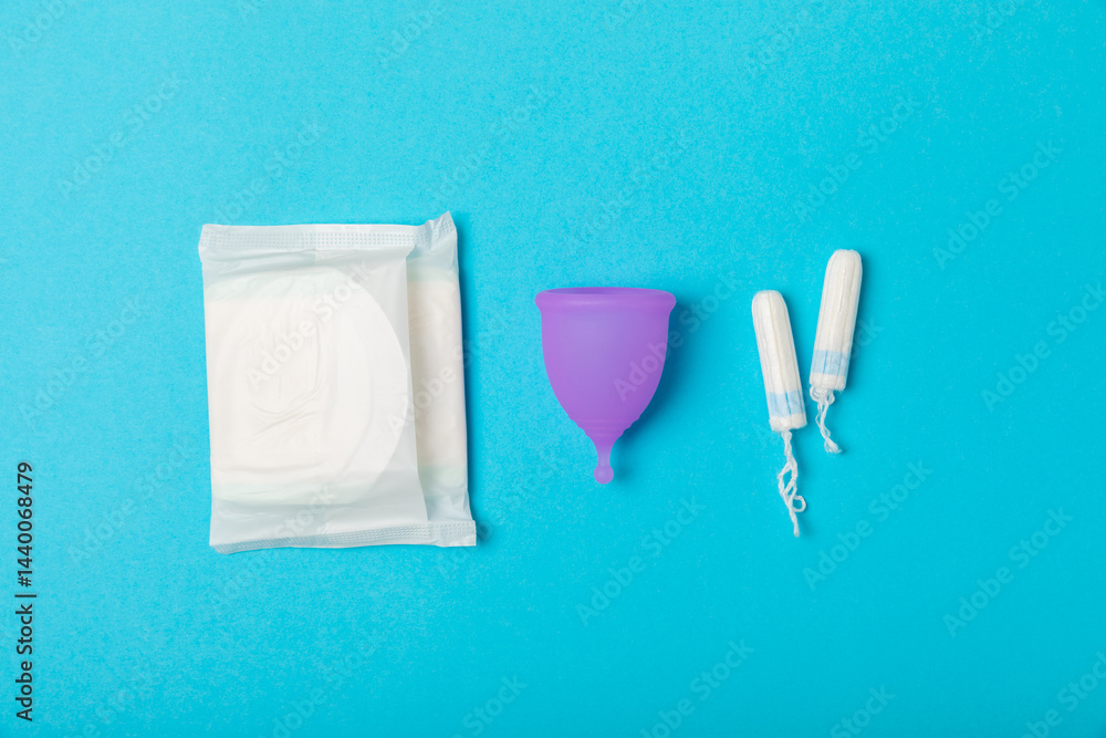 Menstrual cup on a bright background. Sanitary napkins, tampons and menstrual cup.Concept of critical days, menstruation.feminine hygiene product. Women health concept.Premenstrual syndrome.Copy space