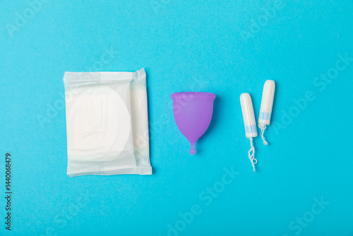 Obraz na płótnie Menstrual cup on a bright background. Sanitary napkins, tampons and menstrual cup.Concept of critical days, menstruation.feminine hygiene product. Women health concept.Premenstrual syndrome.Copy space w salonie
