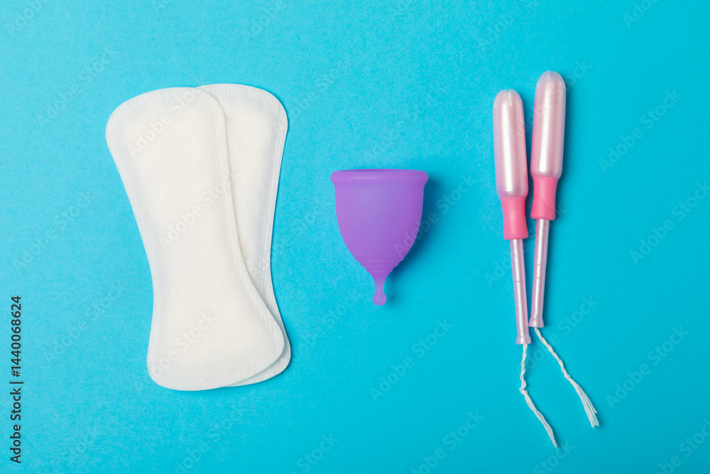 Menstrual cup on a bright background. Sanitary napkins, tampons and menstrual cup.Concept of critical days, menstruation.feminine hygiene product. Women health concept.Premenstrual syndrome.Copy space