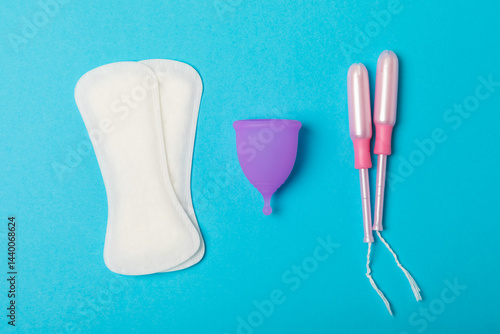 Obraz na płótnie Menstrual cup on a bright background. Sanitary napkins, tampons and menstrual cup.Concept of critical days, menstruation.feminine hygiene product. Women health concept.Premenstrual syndrome.Copy space w salonie