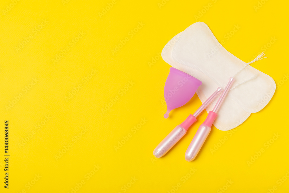 Menstrual cup on a bright background. Sanitary napkins, tampons and menstrual cup.Concept of critical days, menstruation.feminine hygiene product. Women health concept.Premenstrual syndrome.Copy space