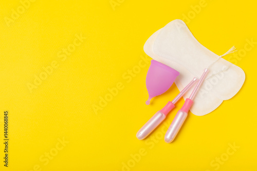 Obraz na płótnie Menstrual cup on a bright background. Sanitary napkins, tampons and menstrual cup.Concept of critical days, menstruation.feminine hygiene product. Women health concept.Premenstrual syndrome.Copy space w salonie