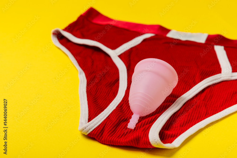 Menstrual cup on a bright background. Sanitary napkins, tampons and menstrual cup.Concept of critical days, menstruation.feminine hygiene product. Women health concept.Premenstrual syndrome.Copy space