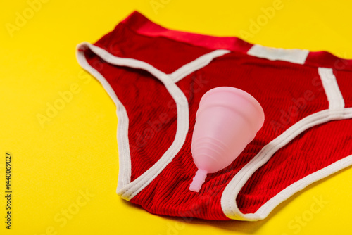 Obraz na płótnie Menstrual cup on a bright background. Sanitary napkins, tampons and menstrual cup.Concept of critical days, menstruation.feminine hygiene product. Women health concept.Premenstrual syndrome.Copy space w salonie