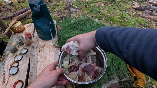 cooking meat on a fire in the forest