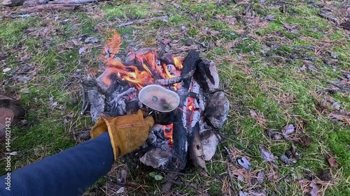 Making a drink on a fire in the forest. Tea. Coffee on the fire.