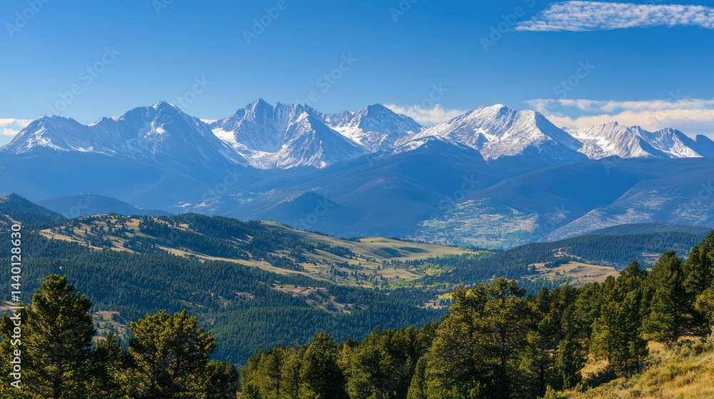 Wide mountain range view with snow-capped peaks, trees, and clear blue sky. Wide mountain range view with snow-capped peaks, trees, and clear blue sky.