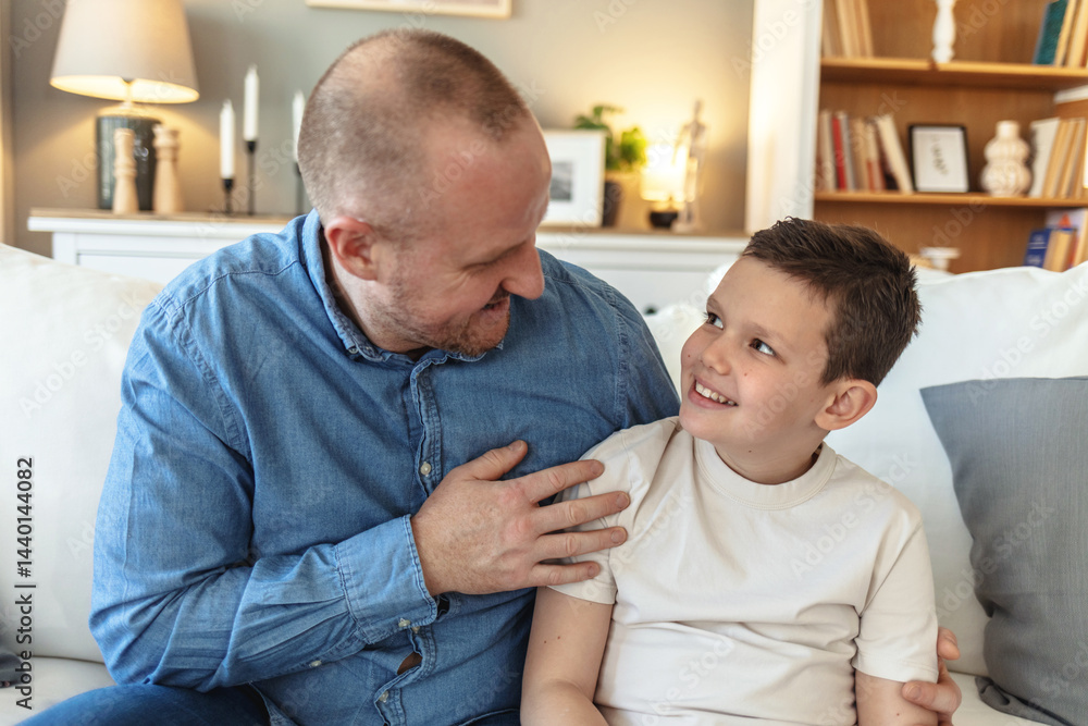 Family, smile or talking with dad and son on sofa in living room of home together for development. Bonding, happy or love with boy child and single parent man in apartment for advice or chat. Family, smile or talking with dad and son on sofa in living room of home together for development. Bonding, happy or love with boy child and single parent man in apartment for advice or chat.