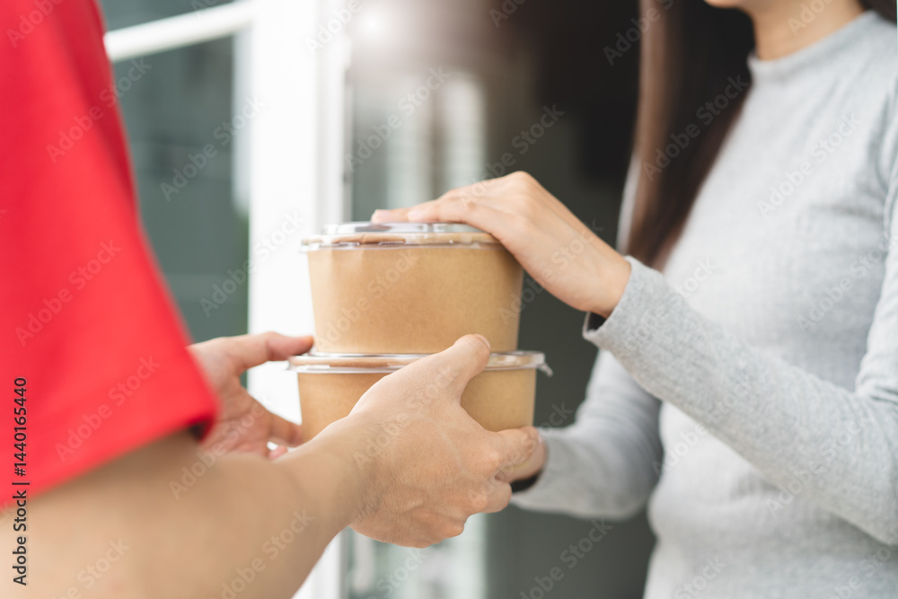 Client receiving lunch box from delivery man at home. Client receiving lunch box from delivery man at home.