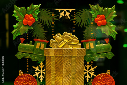 Christmas decoration featuring golden gift, green train and red balls