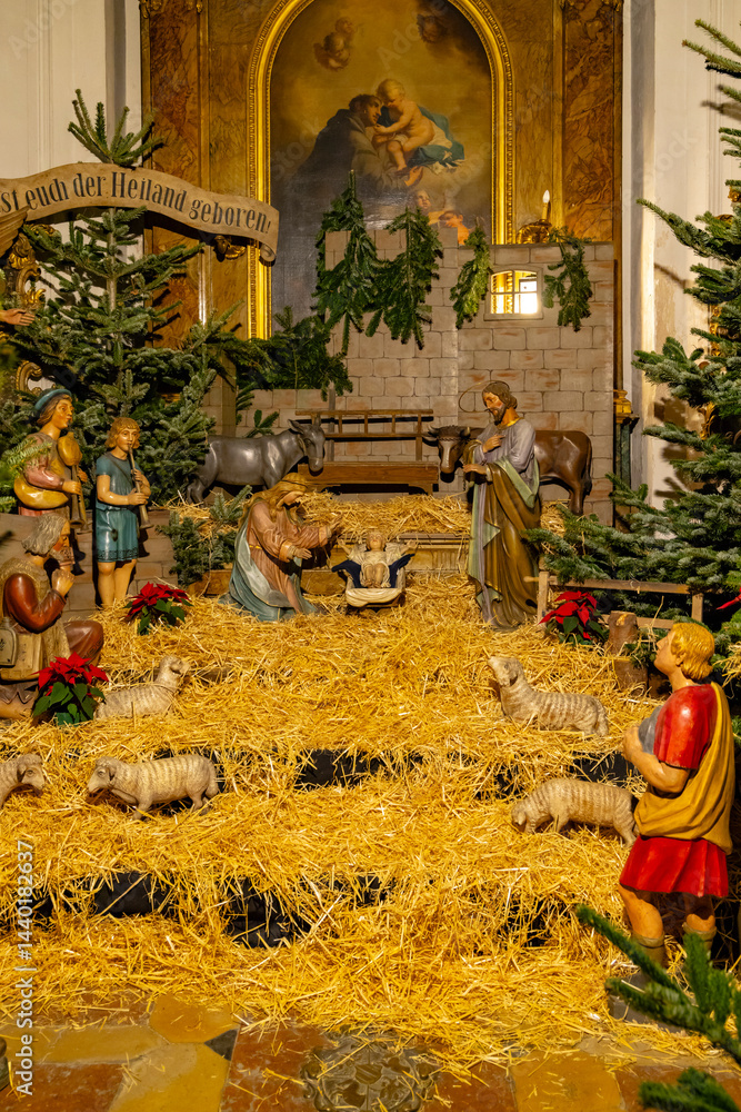 Nativity scene with wooden statues representing the birth of Jesus Christ in a church