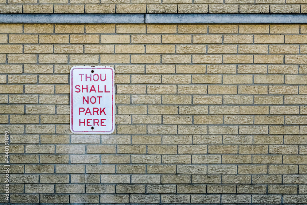 Fototapeta premium thou shall not park here sign on brick wall