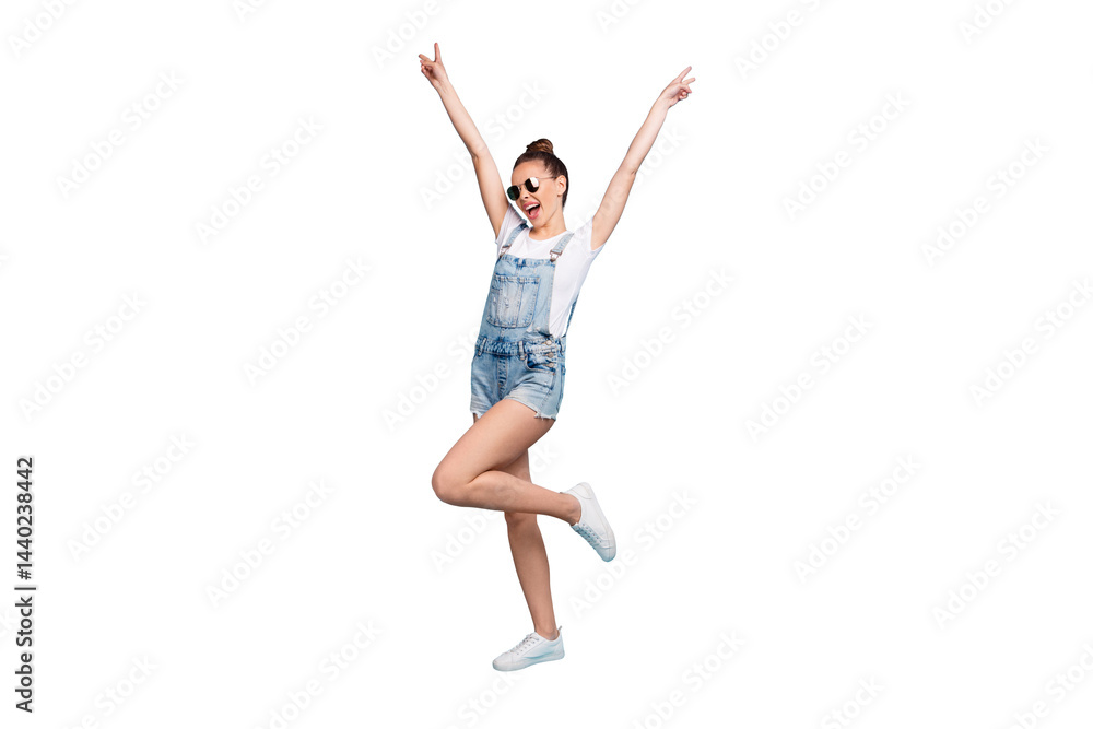 Full length body size photo of chilling dancing walking girl careless wearing jeans denim overall showing everyone v-sign while isolated with blue background Full length body size photo of chilling dancing walking girl careless wearing jeans denim overall showing everyone v-sign while isolated with blue background