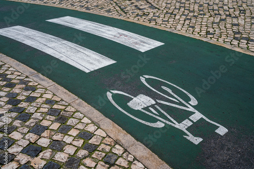 Sign for bicycle painted on the asphalt. Clasical Lisboa Portuquese background.