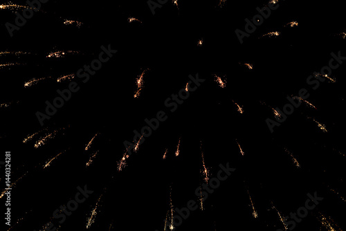 Spectacular golden fireworks show in night sky, shining sparks and trails perfect for celebration and backgrounds