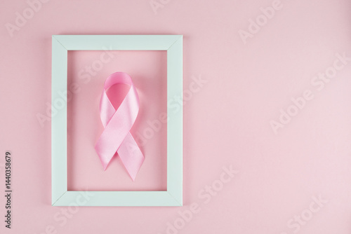 Obraz na płótnie World Breast Cancer Day. Pink ribbon white frame on pink background, w salonie