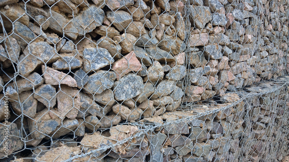 Gabion retaining wall filled with natural stones for landscape reinforcement