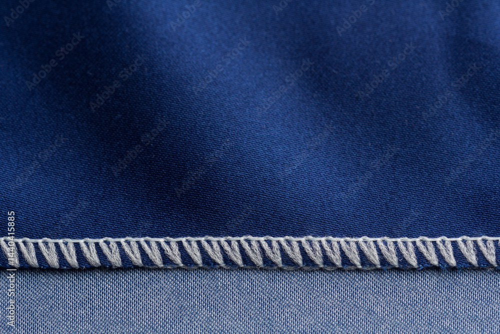 Close up of overlock seam on a blue cloth