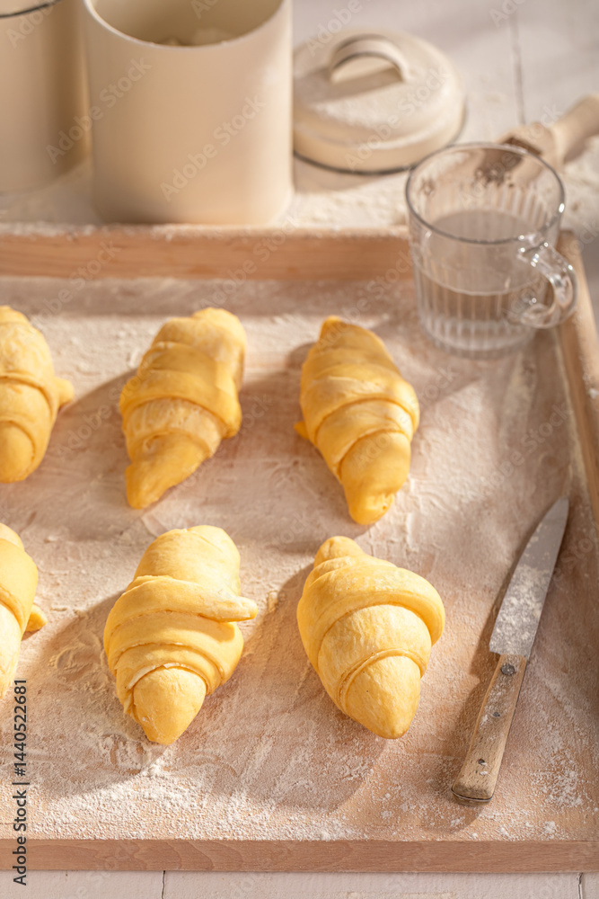 Delicious french croissants preparing from raw dough.