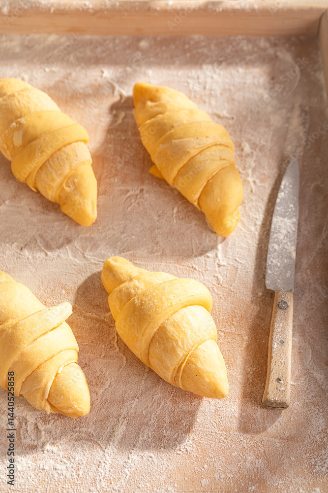 Sweet french croissants prepared on pastry board.