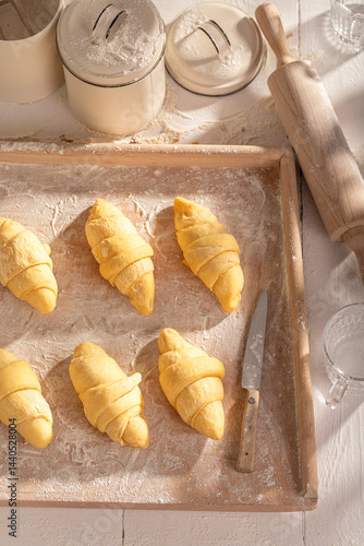 Homemade french croissants prepared on pastry board.