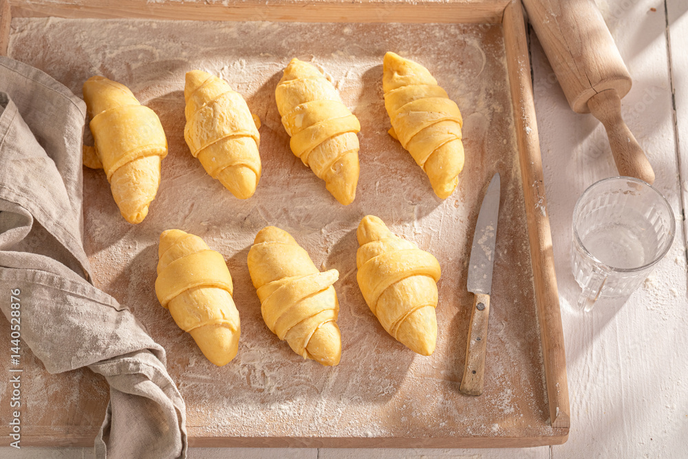 Homemade french croissants preparation for baking in home.