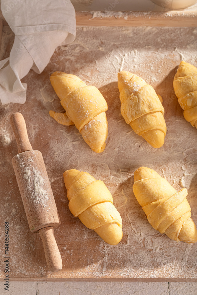 Traditionally french croissants cutting from raw dough
