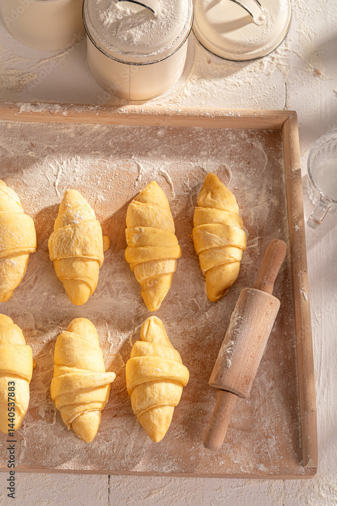 Homemade french croissants preparation before baking in oven.
