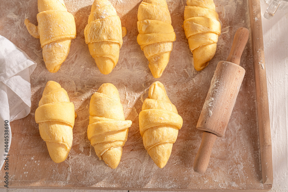 Homemade french croissants cutting from raw dough