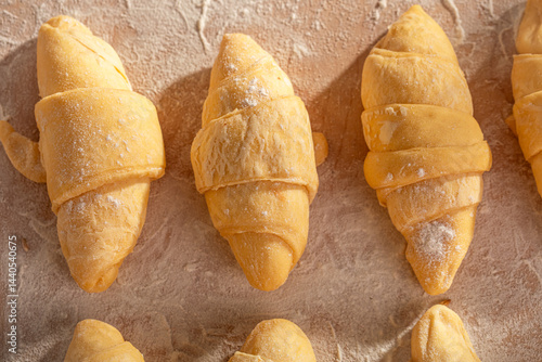 Traditionally french croissants prepared on pastry board.