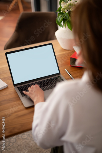 Wallpaper Mural Rear view of a woman's hand typing on a laptop screen Torontodigital.ca