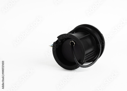 Black Round Inground Outdoor LED Light with Side Openings and Exposed Wires Isolated on White Background

