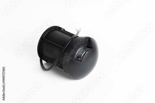 Black Round Inground Outdoor LED Light with Side Openings and Exposed Wires Isolated on White Background


