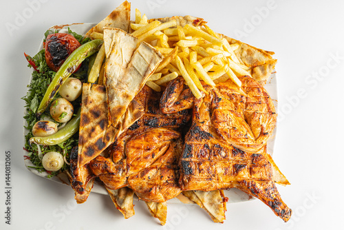 Grilled Chicken with French Fries, Flatbread, and Vegetables on a Plate Isolated on White Background

