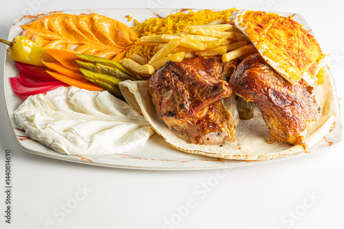 Grilled Chicken Plate with Rice, Fries, Flatbread, and Middle Eastern Appetizers Isolated on White Background

