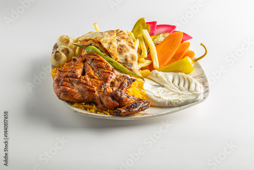 Grilled Chicken with French Fries, Flatbread, and Vegetables on a Plate Isolated on White Background

